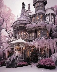 a large victorian style house covered in snow