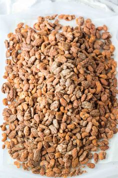 a pile of dry dog food sitting on top of a white plate with brown flecks