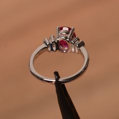 It is lab ruby ring. The main stone is 7 mm*9 mm oval cut.weight about 2.32 carats. The basic metal is sterling silver and plated with rhodium. To change the metal to a solid gold (white/rose) or platinum is also available, please ask for a quotation if you want. You can also go to my shop Home for more elegant rings: https://www.etsy.com/shop/godjewelry?ref=hdr_shop_menu Ruby is July birthstone More ruby rings: https://www.etsy.com/shop/godjewelry?section_id=20709238 Customization is always wel Oval Ruby Ring With Prong Setting In Sterling Silver, Oval Ruby Ring With Sterling Silver Setting, Silver Birthstone Ring With Round-cut Lab-created Ruby, Silver Ruby Ring With Round Cut Lab-created Ruby, Ruby Wedding Ring, Silver Ruby Ring With Hallmark, Round Cut, Elegant Rings, Ruby Wedding Rings, Ruby Rings