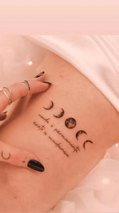 a woman's stomach with her hand on the side of her belly and three phases of the moon