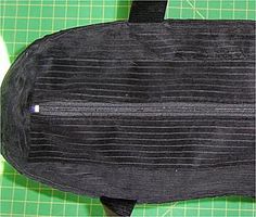 a black bag sitting on top of a green cutting board