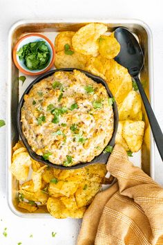 a tray filled with potato chips and dip