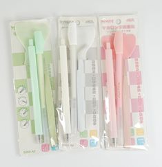 three different colored pens in plastic packaging