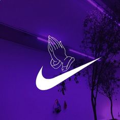 the nike logo is shown in front of a purple background with trees and lights behind it