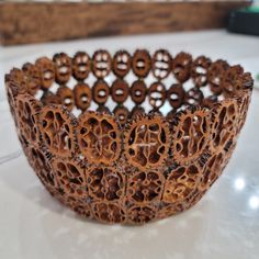 a close up of a wooden bracelet on a table