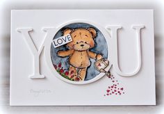 a card with a teddy bear on it and the word you spelled out in white