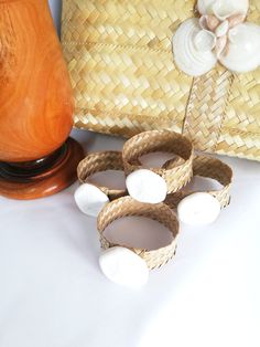 three wicker baskets sitting on top of a table next to a vase and lamp