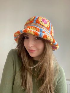 a woman with long hair wearing a colorful hat