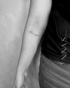 a woman's arm with a small tattoo on the left side of her arm