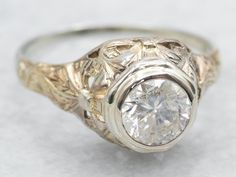 an antique style diamond ring with filigrees