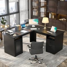 an office desk with two chairs and a computer monitor on top of it in front of a large window