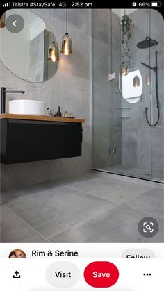 a bathroom with a sink, mirror and shower stall in it's center area