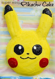 a cake shaped like a pikachu with eyes and ears on it's face