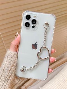 a person holding up an iphone case with a chain attached to the back of it