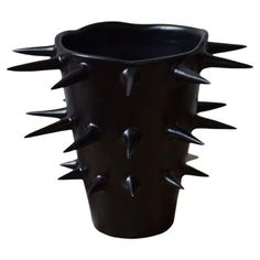 a black vase with spikes on it