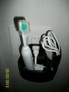 an electric toothbrush is plugged into a wall outlet