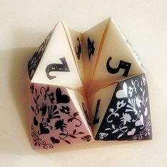 three dices with black and white designs on them sitting next to eachother