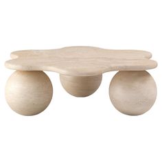 a wooden table with two white balls on the top and one is made out of wood