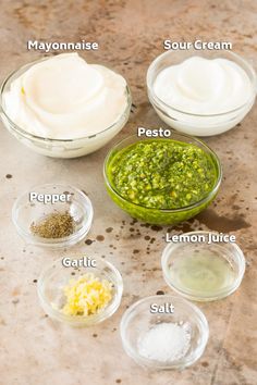 the ingredients to make pesto sauce in small bowls