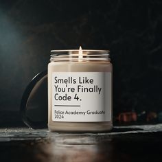 a candle that reads smells like you're finally code 4 police academy graduate on it