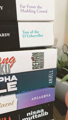 a stack of books sitting on top of each other in front of a computer keyboard