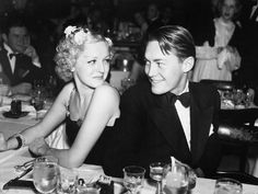 a man and woman sitting at a dinner table