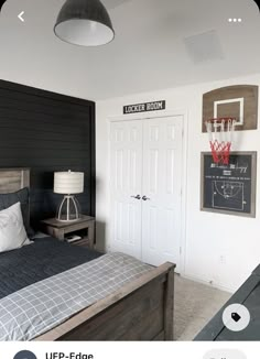 a bed room with a neatly made bed and a basketball hoop on the wall above it