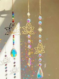 the sun shines brightly in front of some colorful beads hanging from a window sill