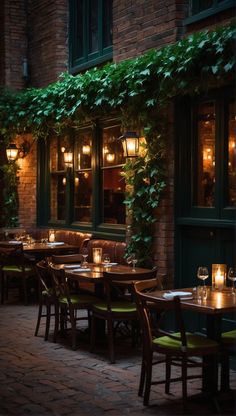 an outdoor dining area with tables, chairs and candles lit by lanterns on the windows