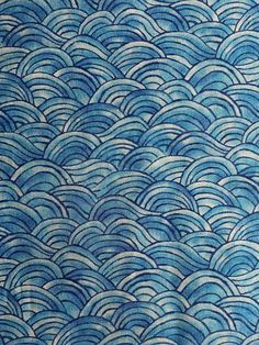 a blue and white fabric with waves on it