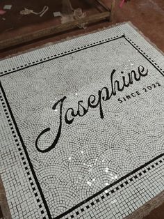 a tile floor with the word japenine on it and an ornate border around it