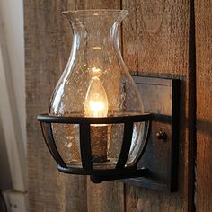 a light that is on the side of a wooden wall next to a lamp fixture