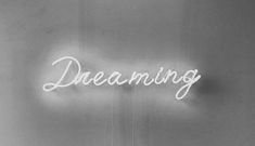 a neon sign that reads dreaming