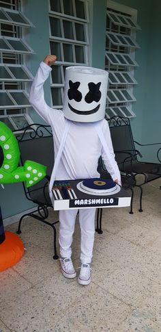 a man dressed as marshmallow holding a record player