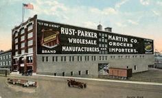 an old postcard shows the exterior of a building with cars parked in front of it