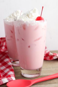 two glasses filled with ice cream and cherries