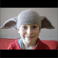 a young boy wearing a knitted hat with ears