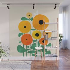 an orange and yellow flower on a white wall mural in a living room with wooden flooring