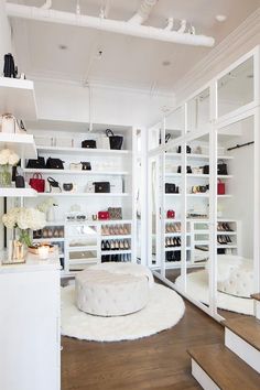 the inside of a shoe store with white shelving and shelves filled with purses