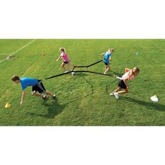 children are playing tug - ball on the grass