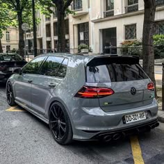 the rear end of a grey volkswagen golf gtr parked on the side of a street