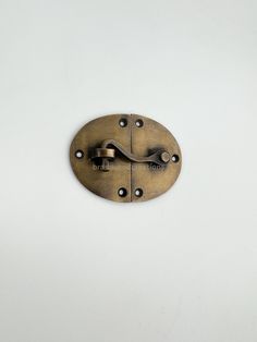 an antique brass door handle on a white wall