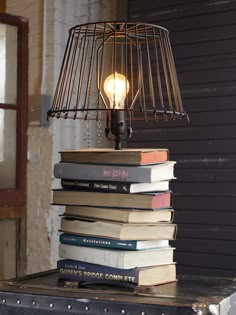 a lamp sitting on top of a stack of books