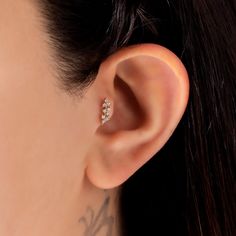 a close up of a person wearing an ear piercing