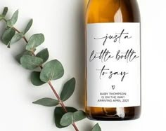 a bottle of wine next to a plant on a white background with the words just a little bottle to say