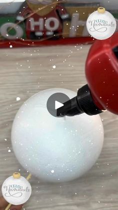 a white ball with a red handle is being blown by a blow - up christmas ornament