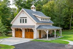 a two car garage with an attached porch