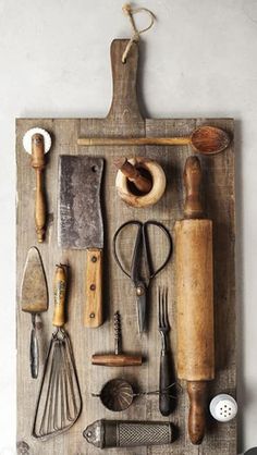 an assortment of kitchen utensils on a cutting board