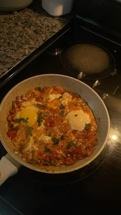 an omelet with eggs in it sitting on top of a stove next to a burner