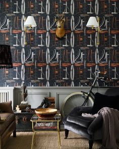 a living room filled with furniture and wallpaper covered in deer head mounted on the wall